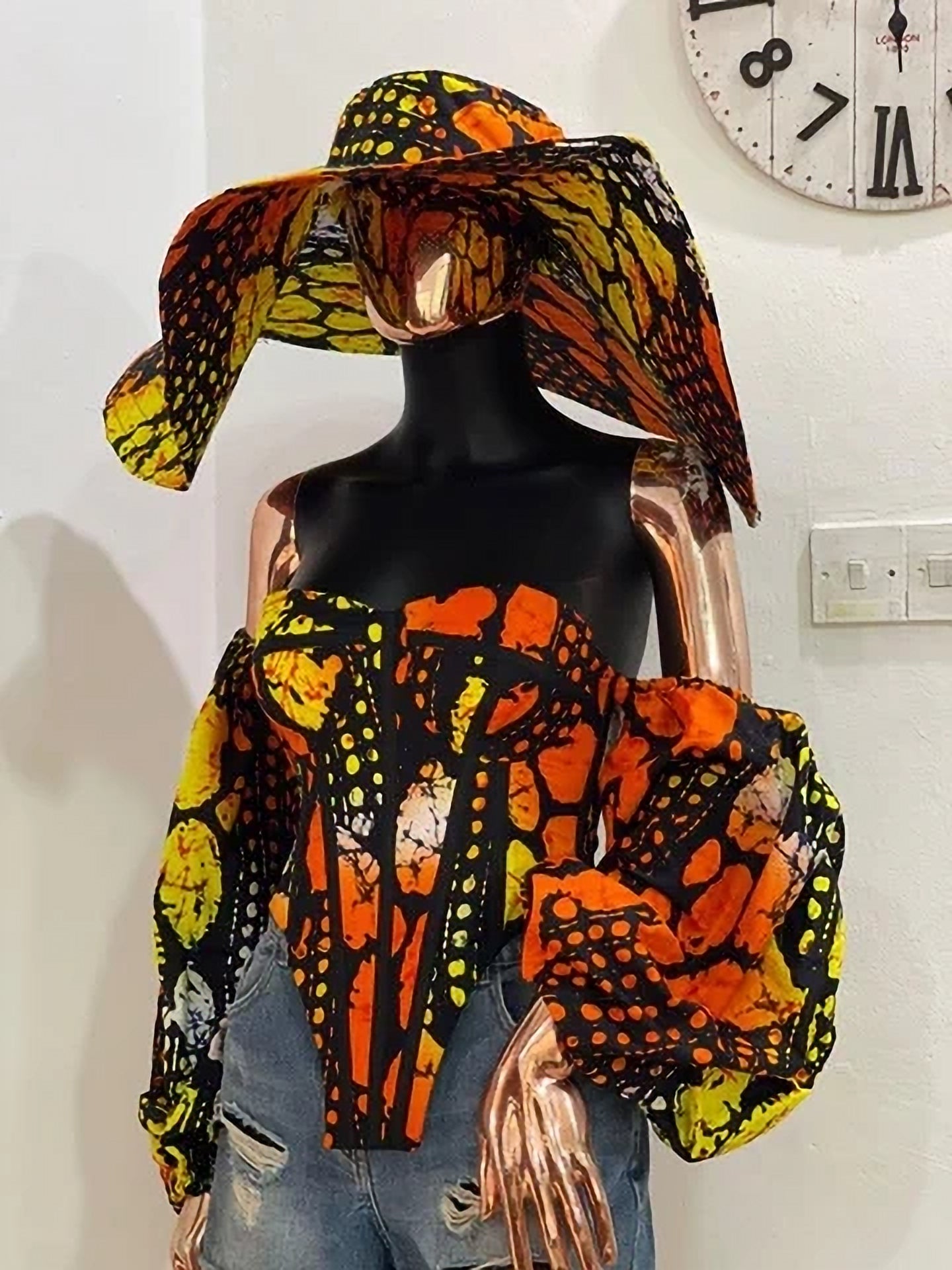 Make a bold statement in this stunning Ankara corset top paired with a matching statement hat. Shop this unique African print set at Fabby Glamtique.