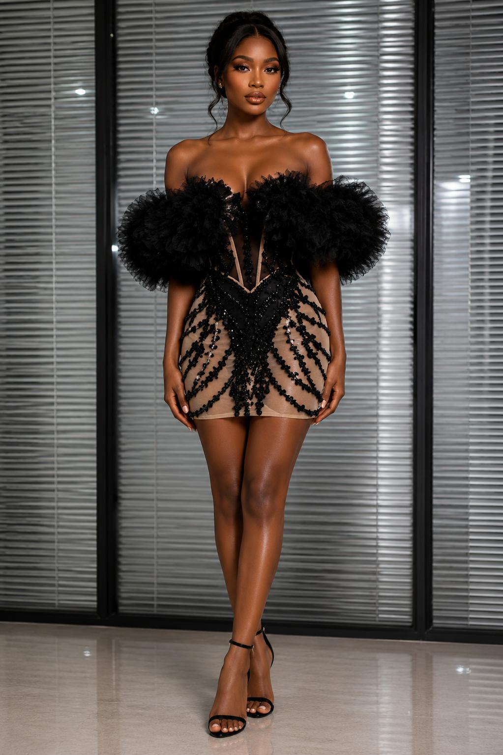 Woman wearing black rhinestone tulle sleeve mini dress with nude illusion mesh, deep plunge neckline, bodycon fit, and elegant party styling. 