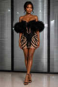 Woman wearing black rhinestone tulle sleeve mini dress with nude illusion mesh, deep plunge neckline, bodycon fit, and elegant party styling. 