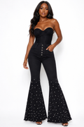 Front view of black pearl-studded high-waist flare jeans with button fly
