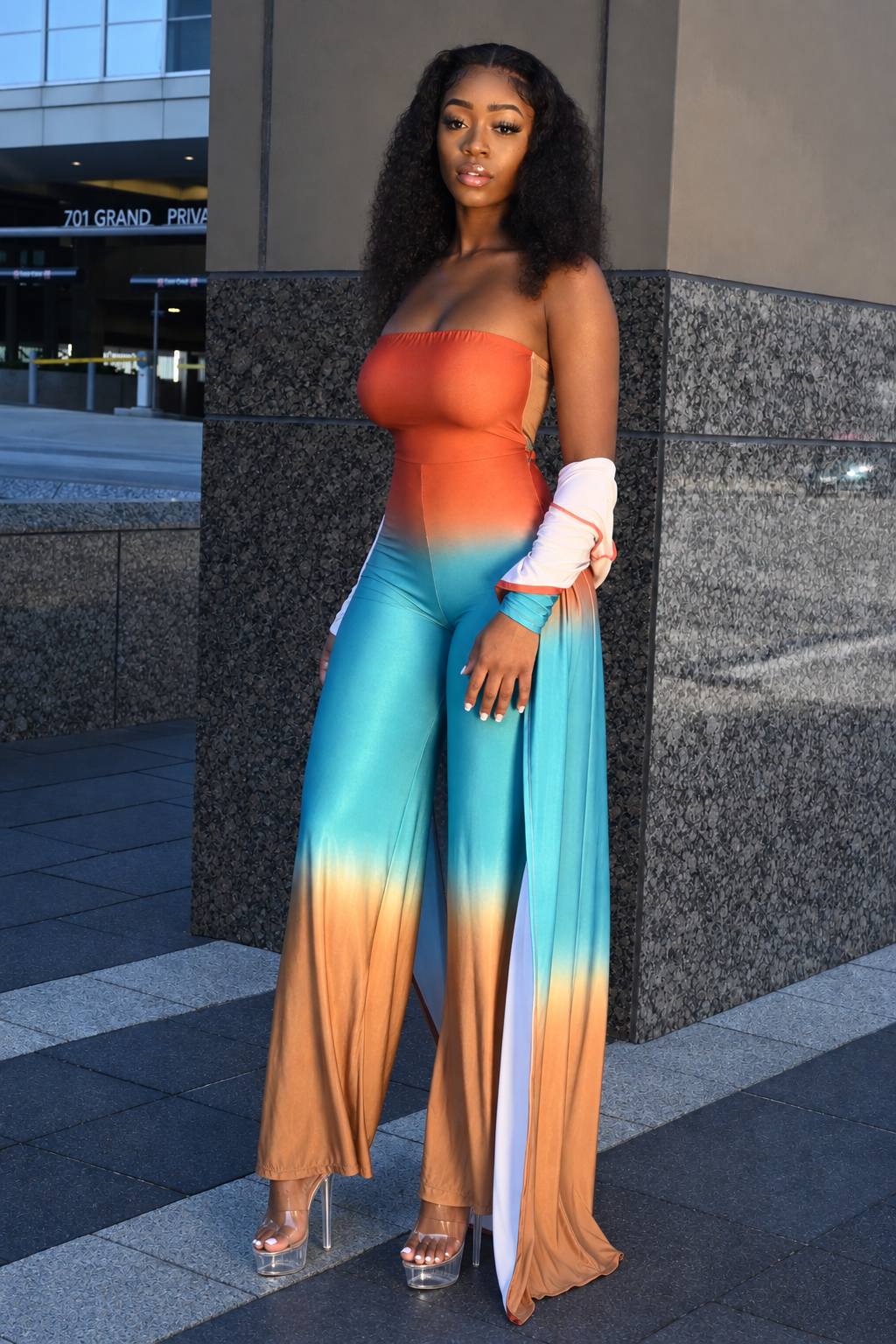 Orange trench jumpsuit two-piece set with fitted jumpsuit and long-sleeve trench sweater overlay
