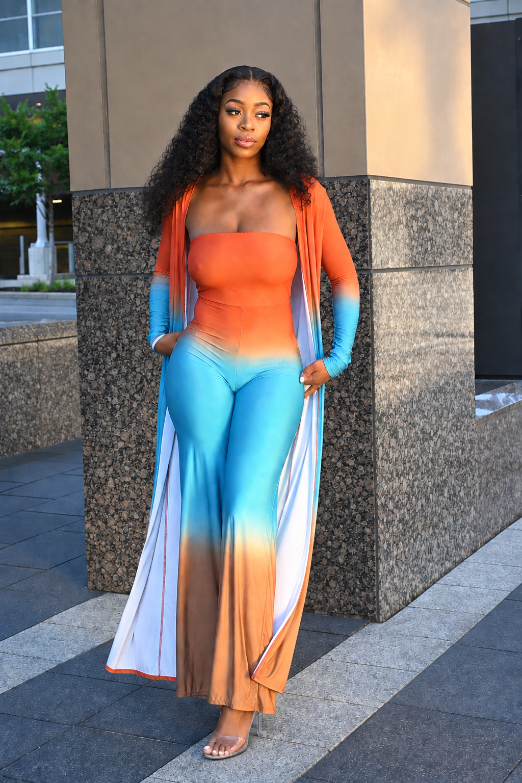 Orange trench jumpsuit two-piece set with fitted jumpsuit and long-sleeve trench sweater overlay