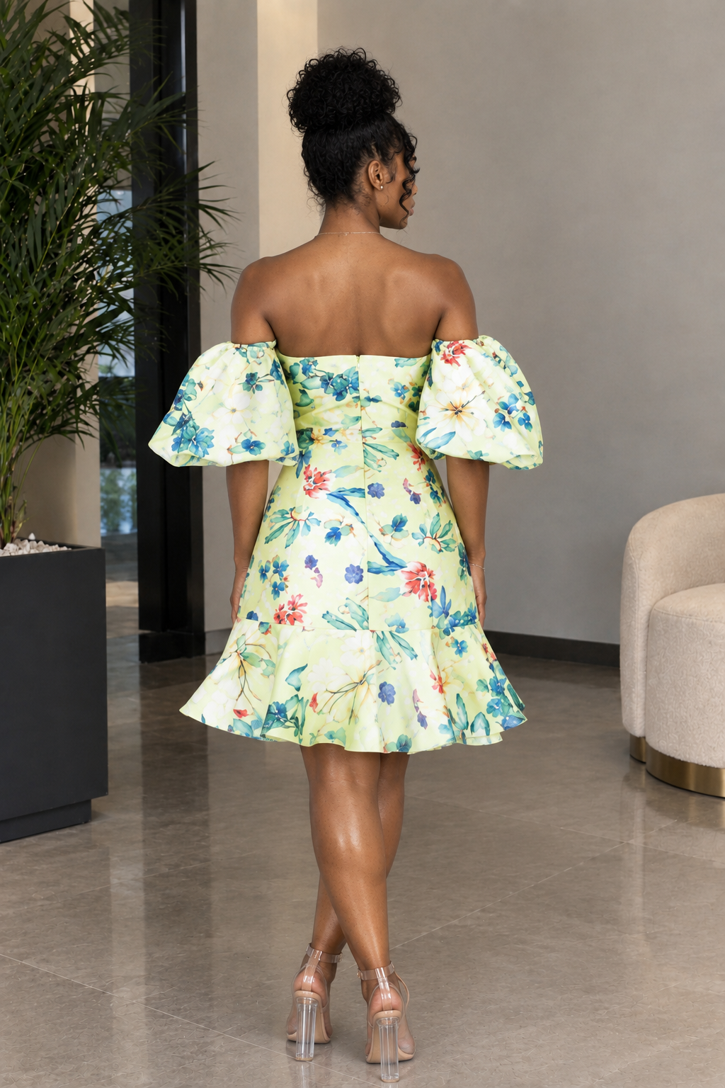 Back view of yellow floral off-shoulder puff sleeve mini dress