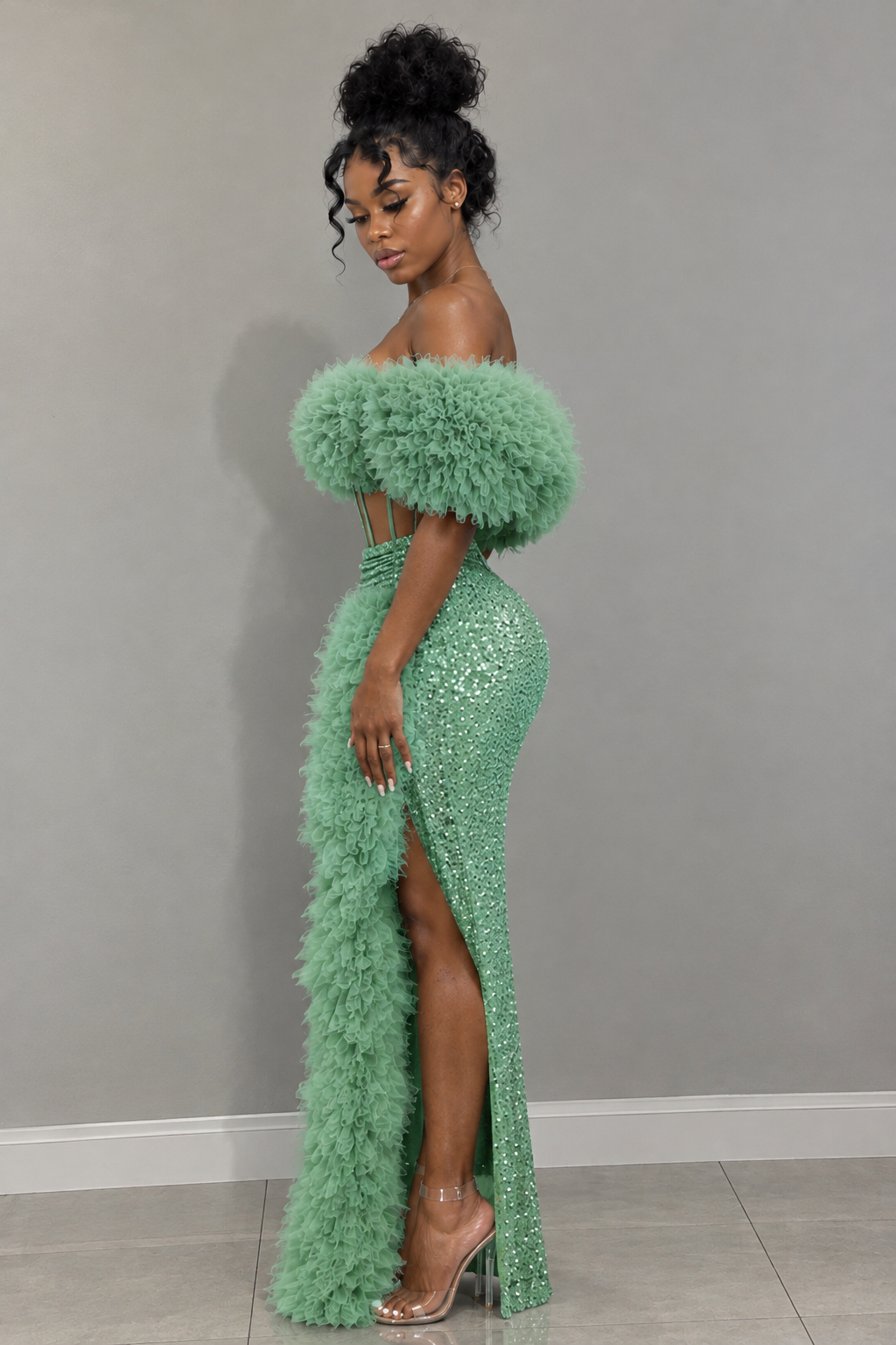 Side view of mint green shimmering maxi gown with feather-style neckline and skirt trim