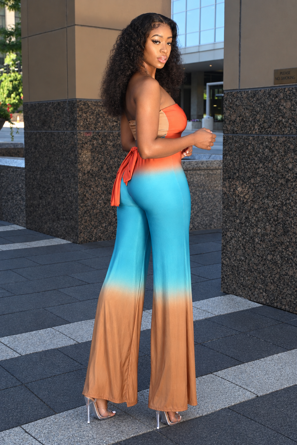 Orange trench jumpsuit two-piece set with fitted jumpsuit and long-sleeve trench sweater overlay