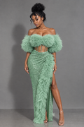 Front view of mint green off-shoulder maxi gown with feather-style trim, corset-style waist and thigh-high slit