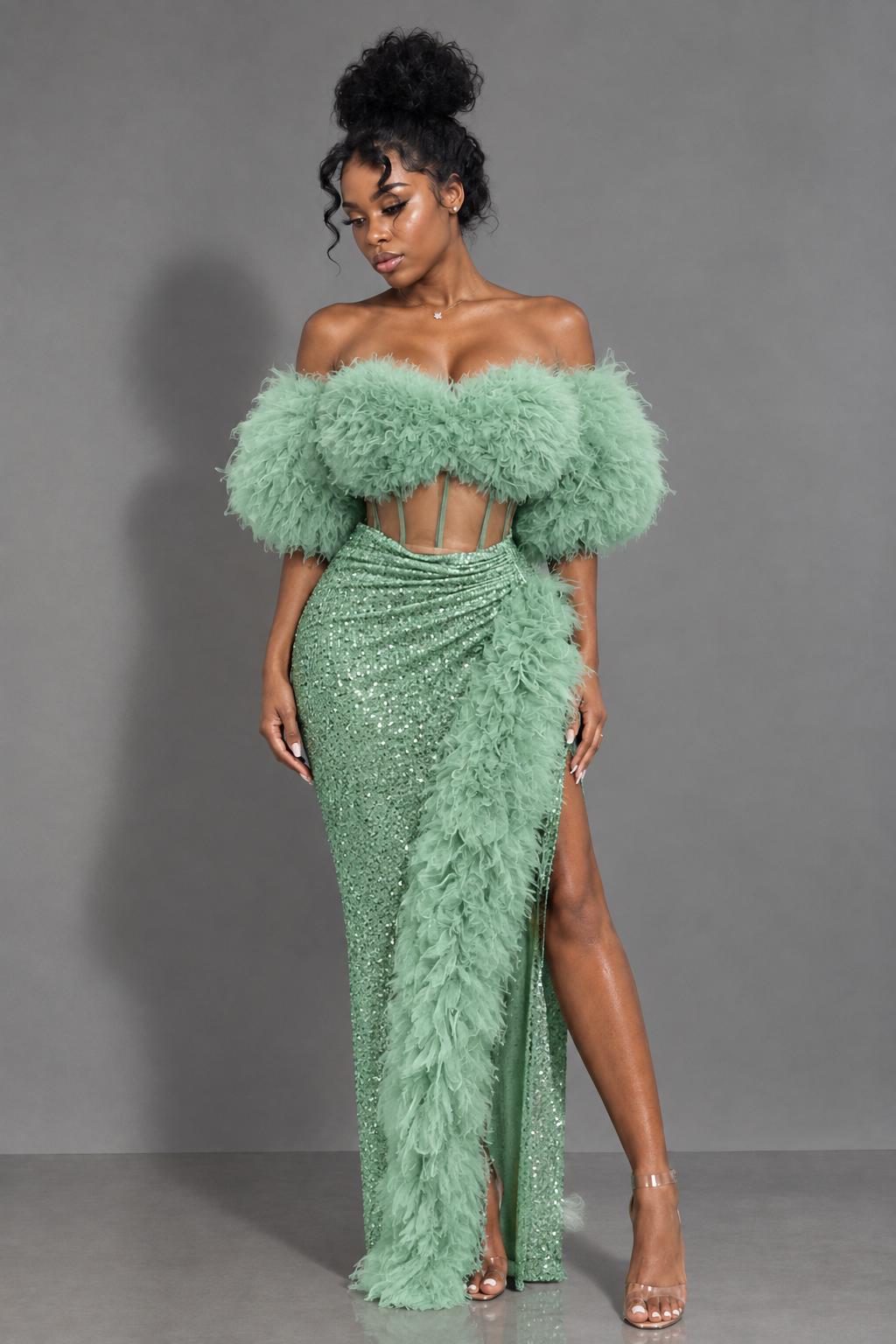 Front view of mint green off-shoulder maxi gown with feather-style trim, corset-style waist and thigh-high slit