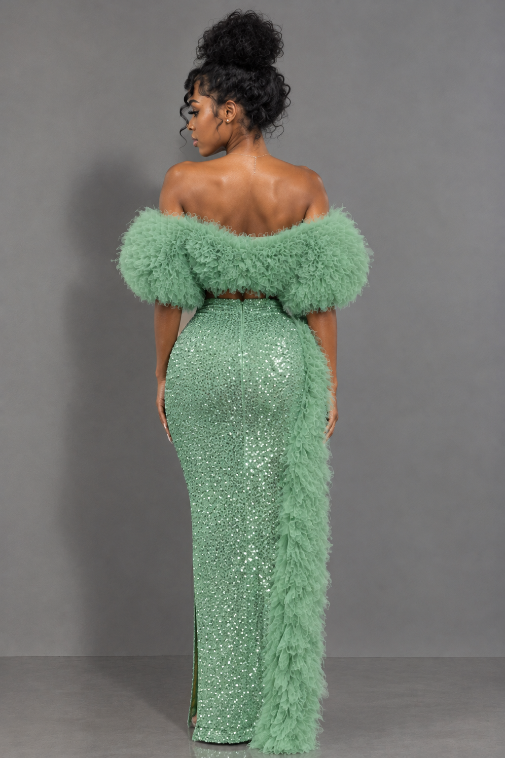Back view of mint green off-shoulder shimmering maxi gown with feather-style trim