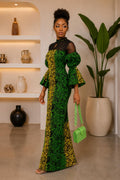 Stylish model wearing an African Print Maxi Dress with vibrant green and yellow Ankara patterns.